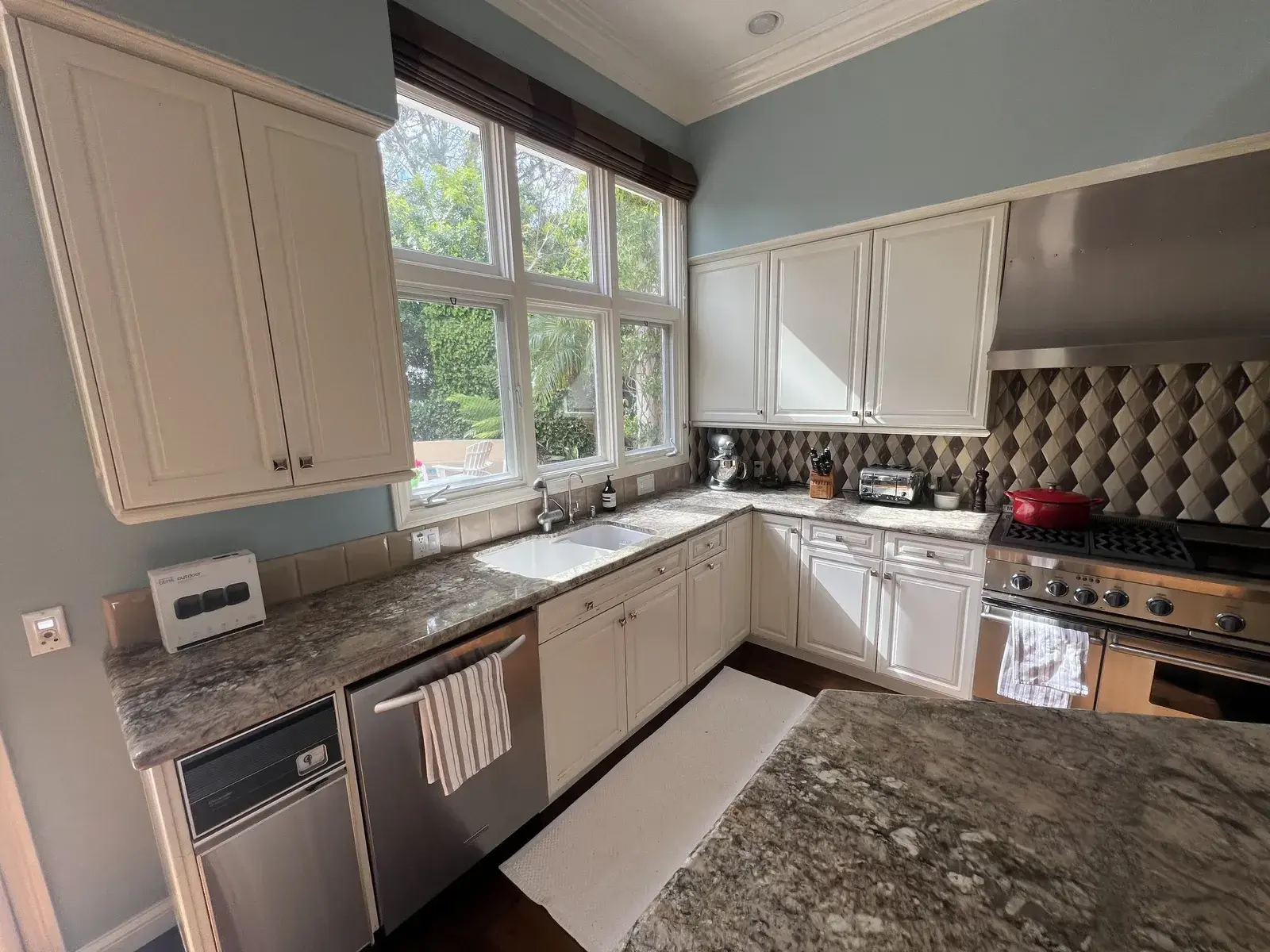 Tired, dated kitchen cabinets before refinishing