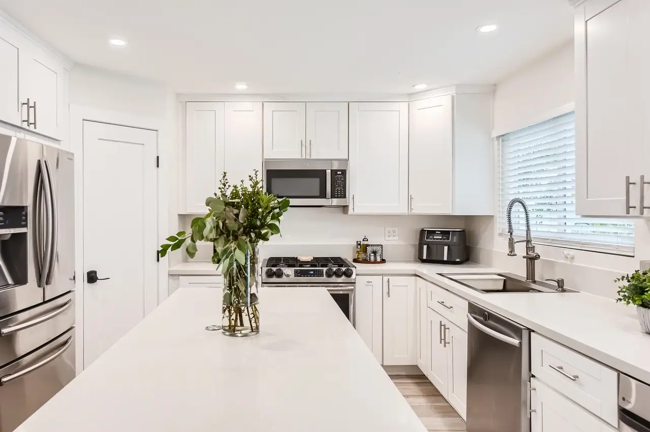 Refinished bright white kitchen cabinets with a smooth sprayed Italian 2K polyurethane finish