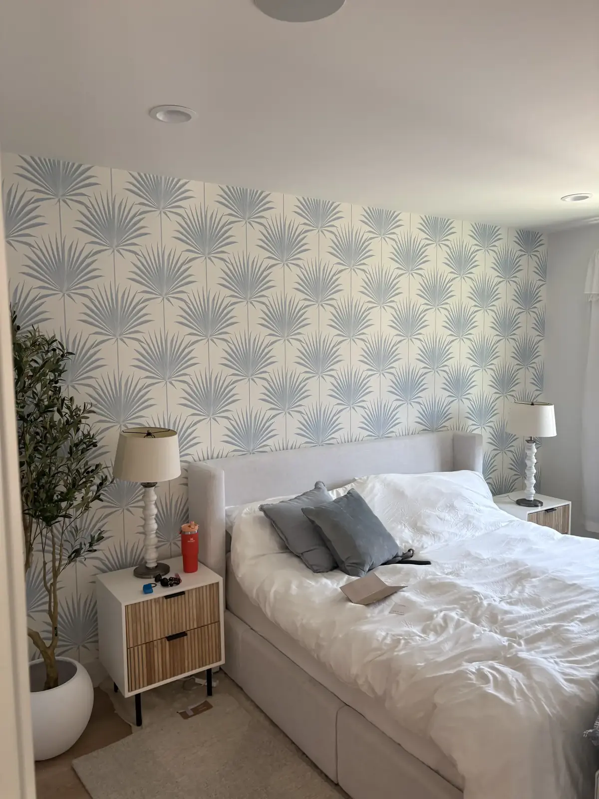 Palm-leaf designer wallpaper accent wall installed with clean seams and matched repeats